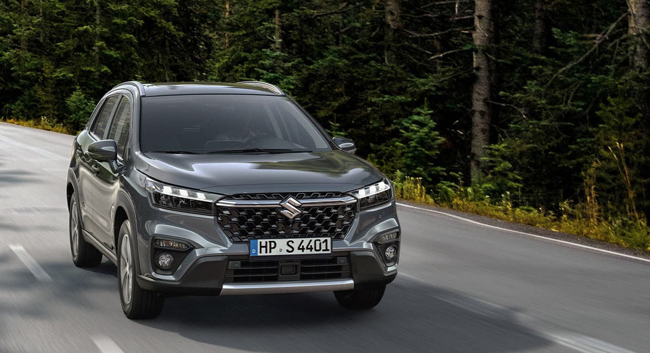 Ein dunkler S-Cross 1.4 BOOSTERJET HYBRID ALLGRIP Comfort+ auf der Straße